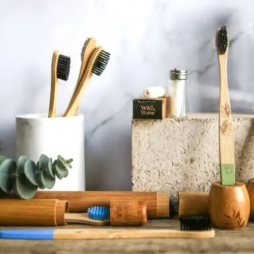 Bamboo toothbrushes displayed on a wooden board