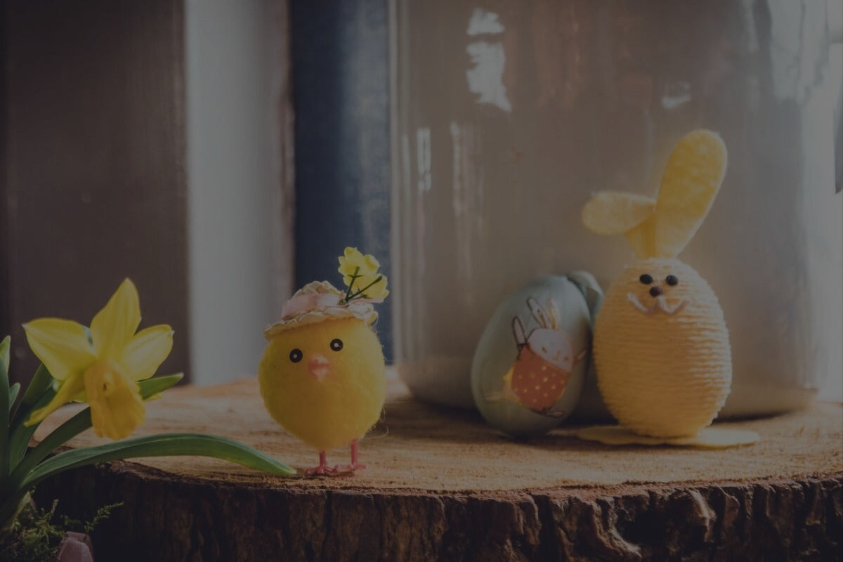 Easter chick and bunny on wooden surface with daffodil