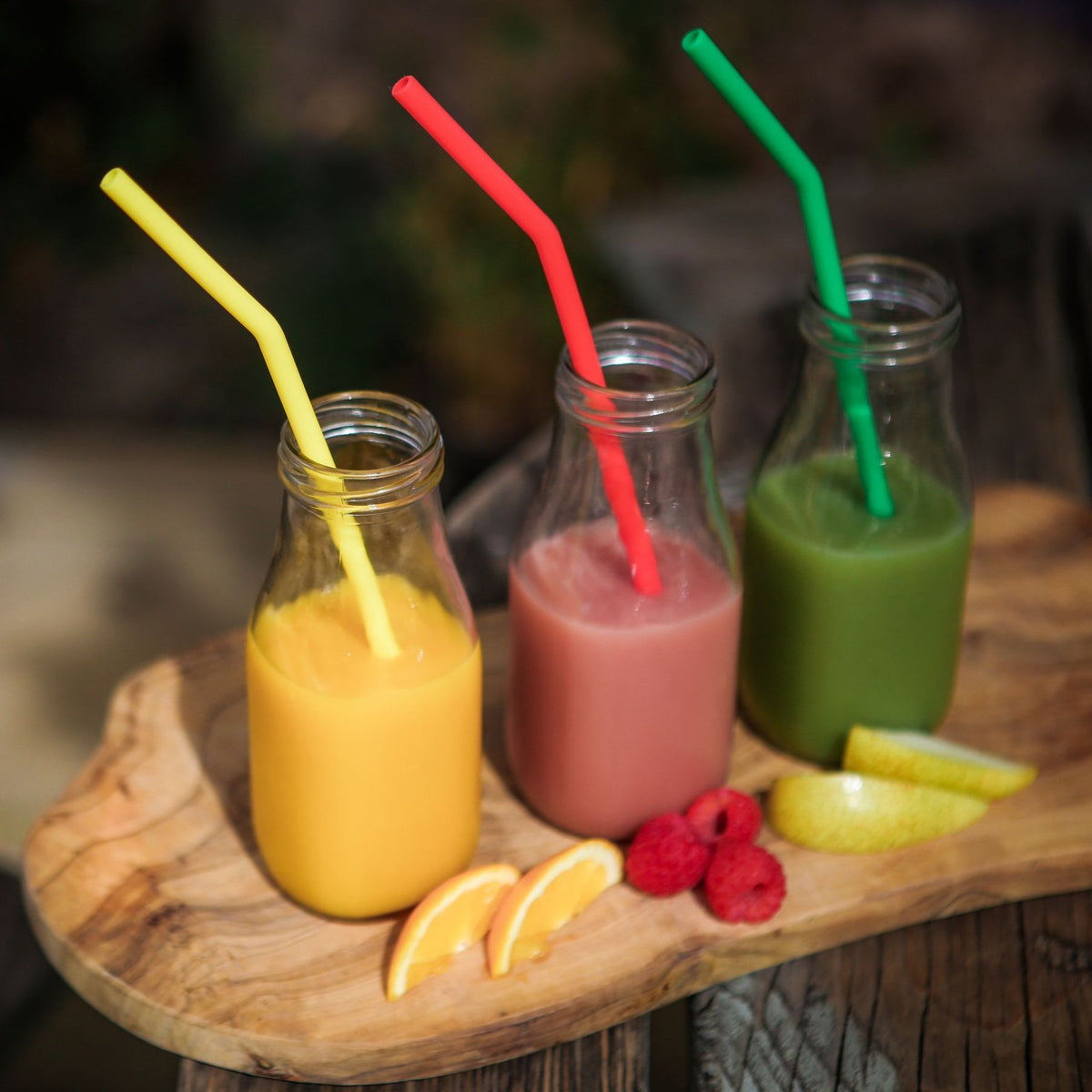 Reusable Silicone Drinking Straws in yellow, pink and green drinks. 