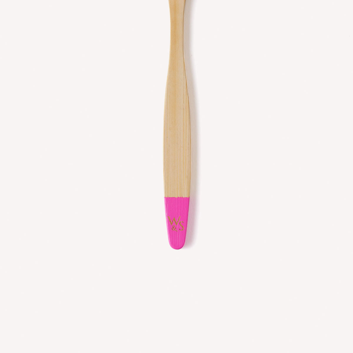 Close up view of the wild & stone logo on our pink children's toothbrush.