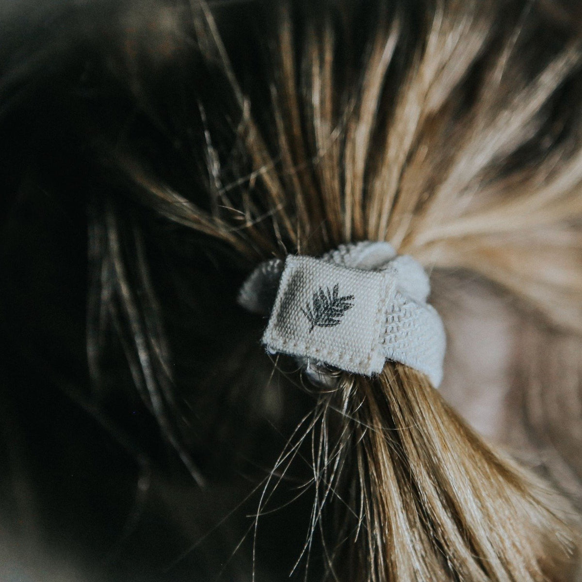 Person wearing our black Plastic Free Hair Ties.