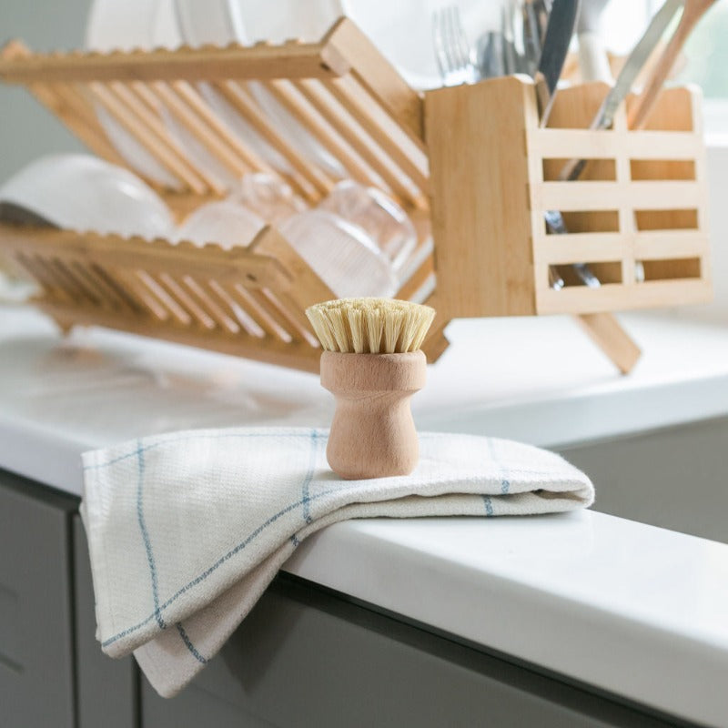 Wooden Pot Brush on the edge of the sink.
