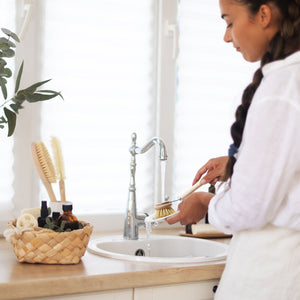 Woman using Wooden Dish Brush with Replaceable Head.